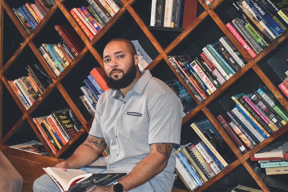 Jermaine reading a book in a coffee shop