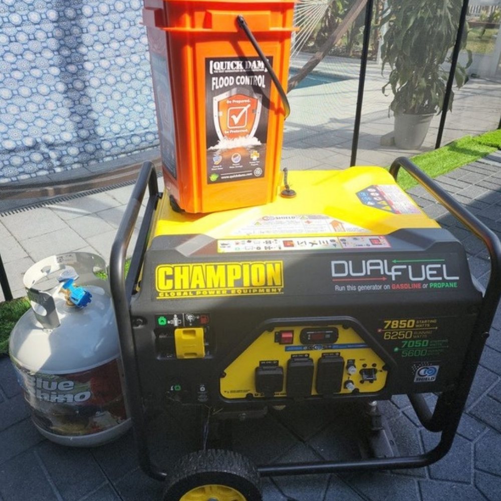Jermaine's dual fuel generator with a propane tank and flood barrier bucket, ready before a storm